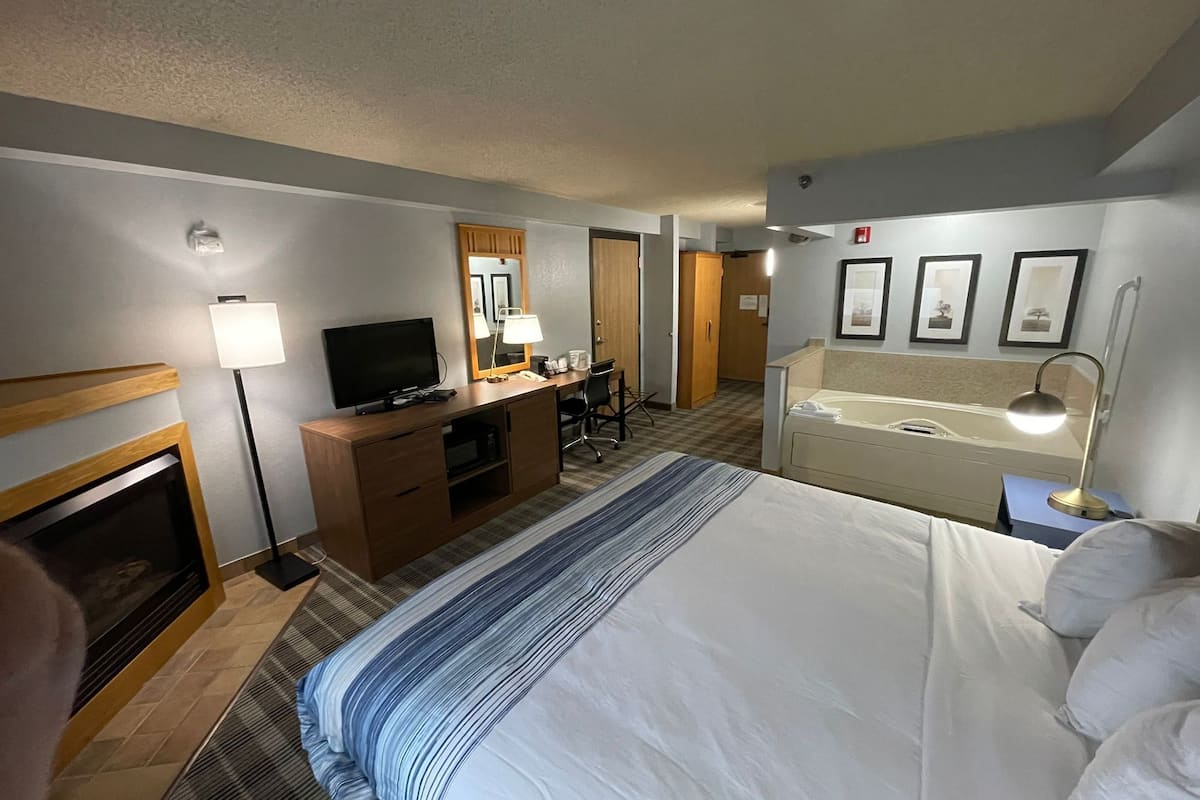 deluxe room, 1 king bed, accessible, non smoking | premium bedding, desk, laptop workspace, iron/ironing board