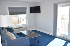 Queen Suite, Deck | Living area | 40-inch flat-screen TV with cable channels, TV