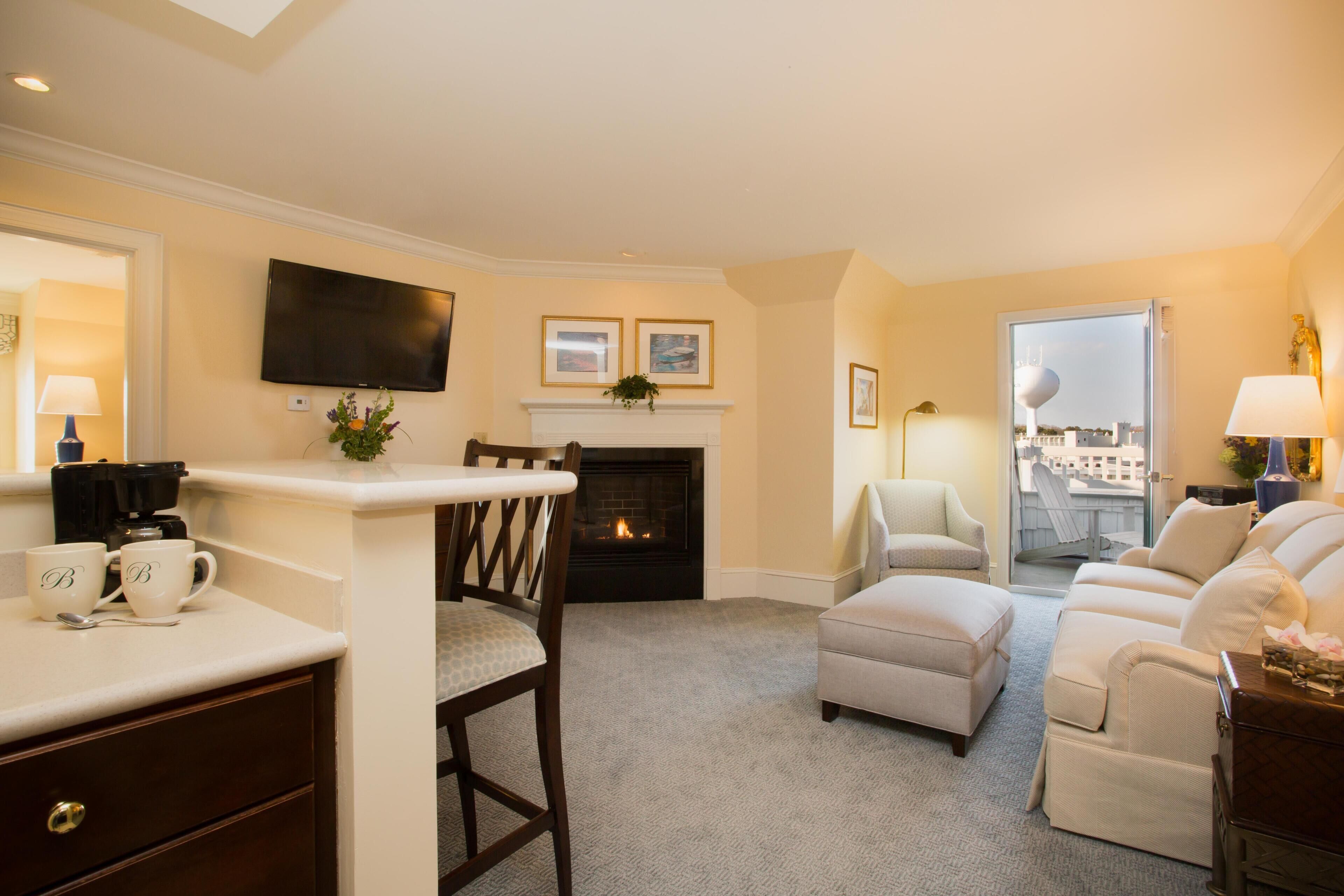 A living room with a fireplace, a television, and a sofa.