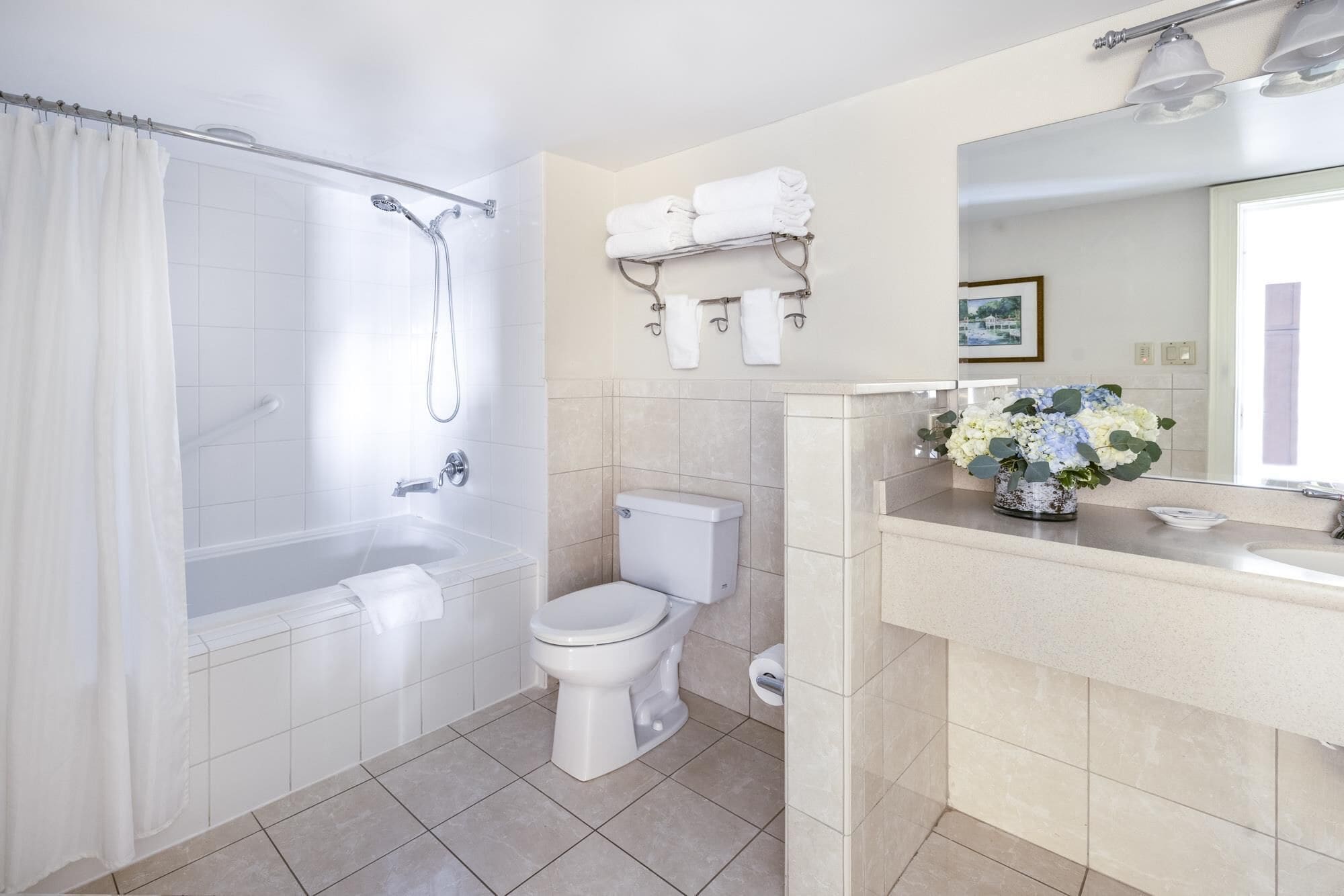 A modern bathroom with a bathtub, toilet, and sink.