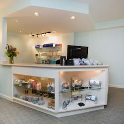 Guests can check in and receive services in this welcoming reception area featuring a reception desk, flat-screen TV, and decorative touches.