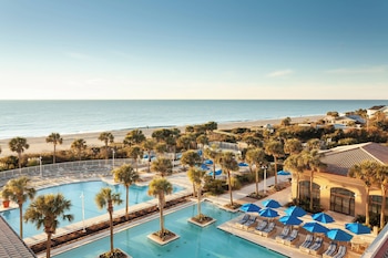 Indoor pool, outdoor pool, open 7:00 AM to 11:00 PM, pool umbrellas at Marriott Myrtle Beach Resort & Spa at Grande Dunes