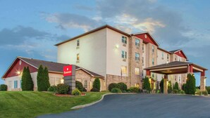 A multi-story hotel with a covered entrance and a sign indicating it is a Ramada hotel.