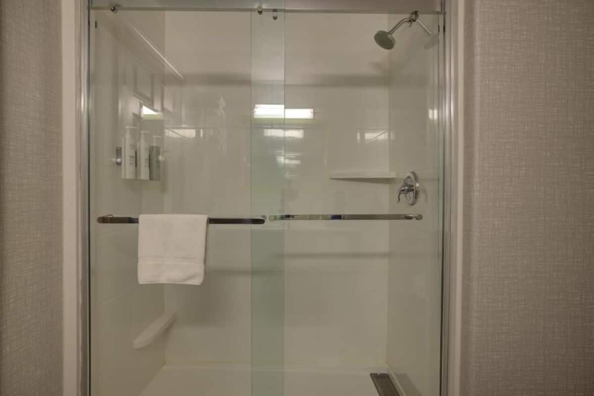 combined shower/bathtub, designer toiletries, hair dryer, towels
