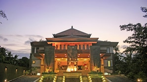 A large, modern building with a prominent entrance and a central statue. - Pelangi Bali Hotel & Spa (Seminyak)