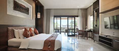 A modern hotel room with a large bed, a TV, a dining area, and a balcony with curtains.