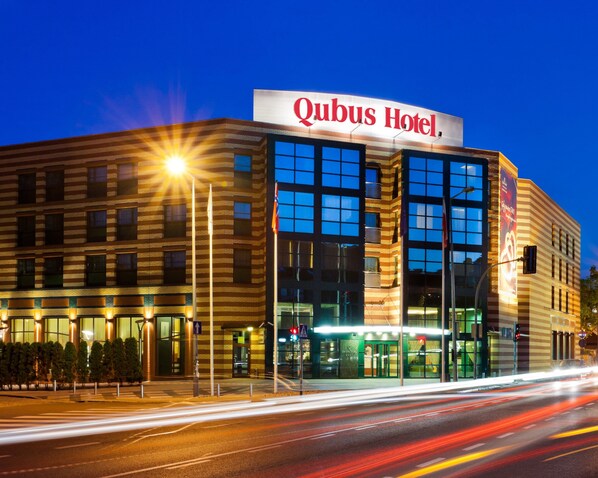 A hotel with a prominent sign reading "Qubus Hotel."