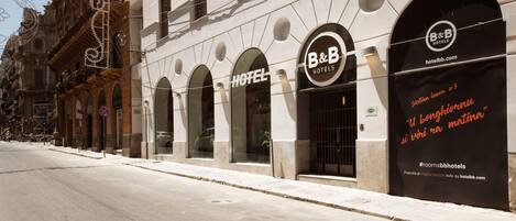 A B&B hotel facade with arched windows and a prominent sign.