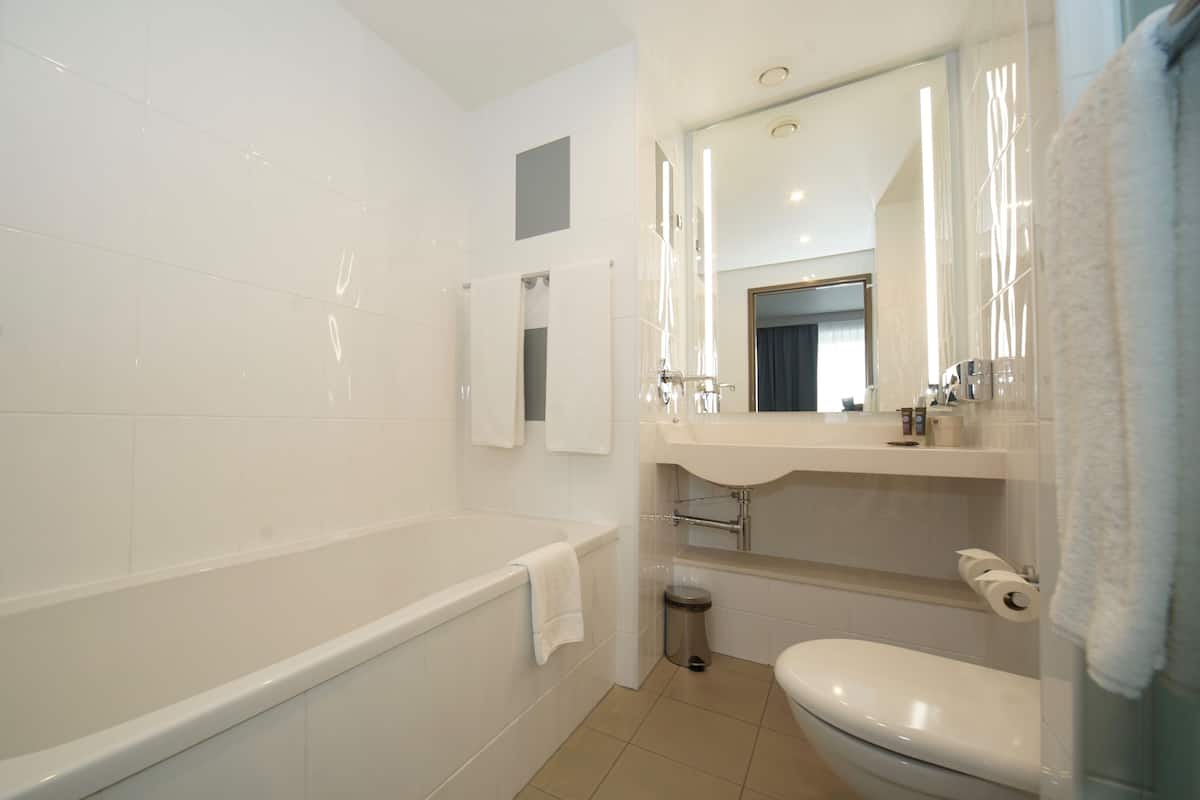 separate bathtub and shower, eco-friendly toiletries, hair dryer, towels
