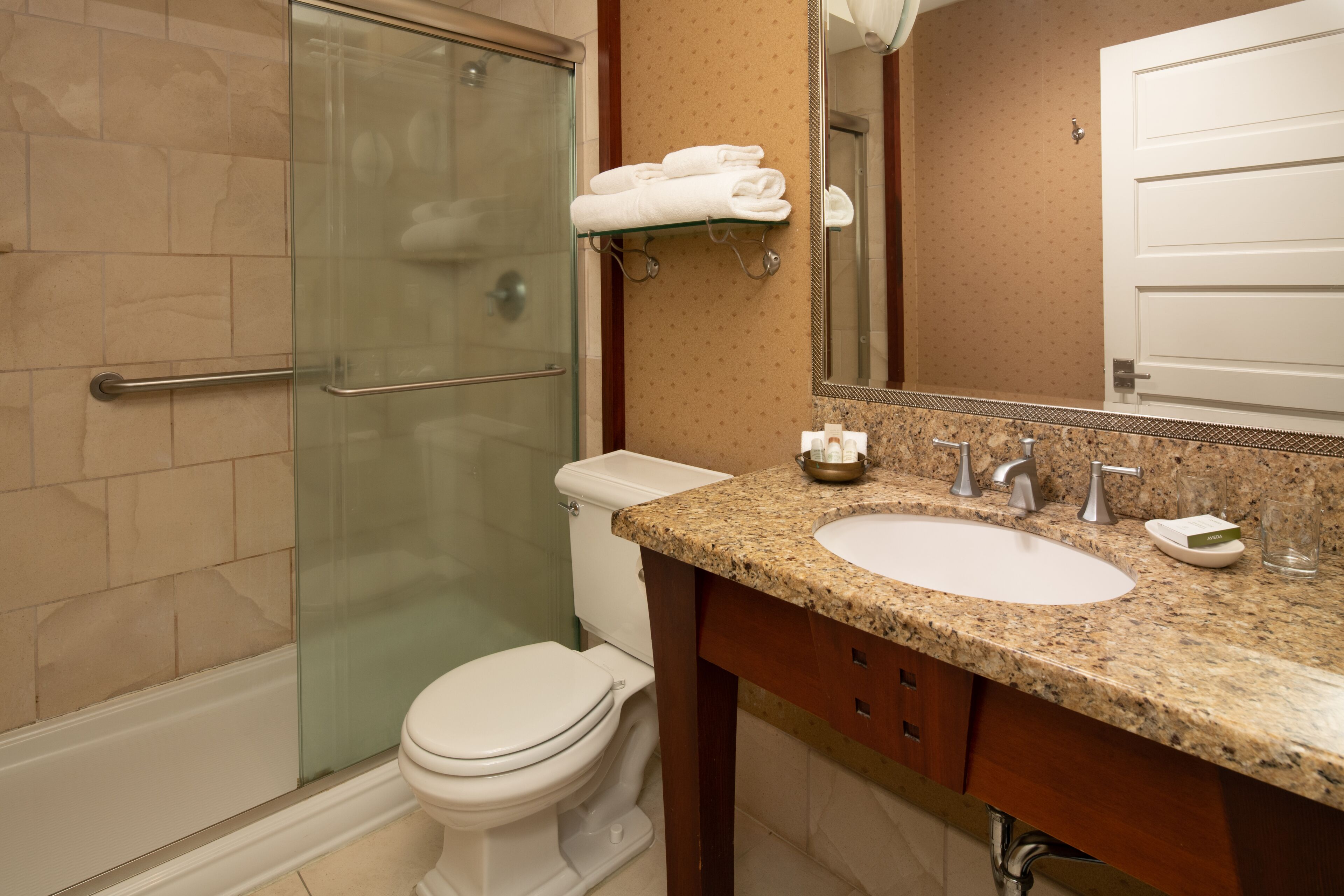 combined shower/bathtub, designer toiletries, hair dryer, bathrobes