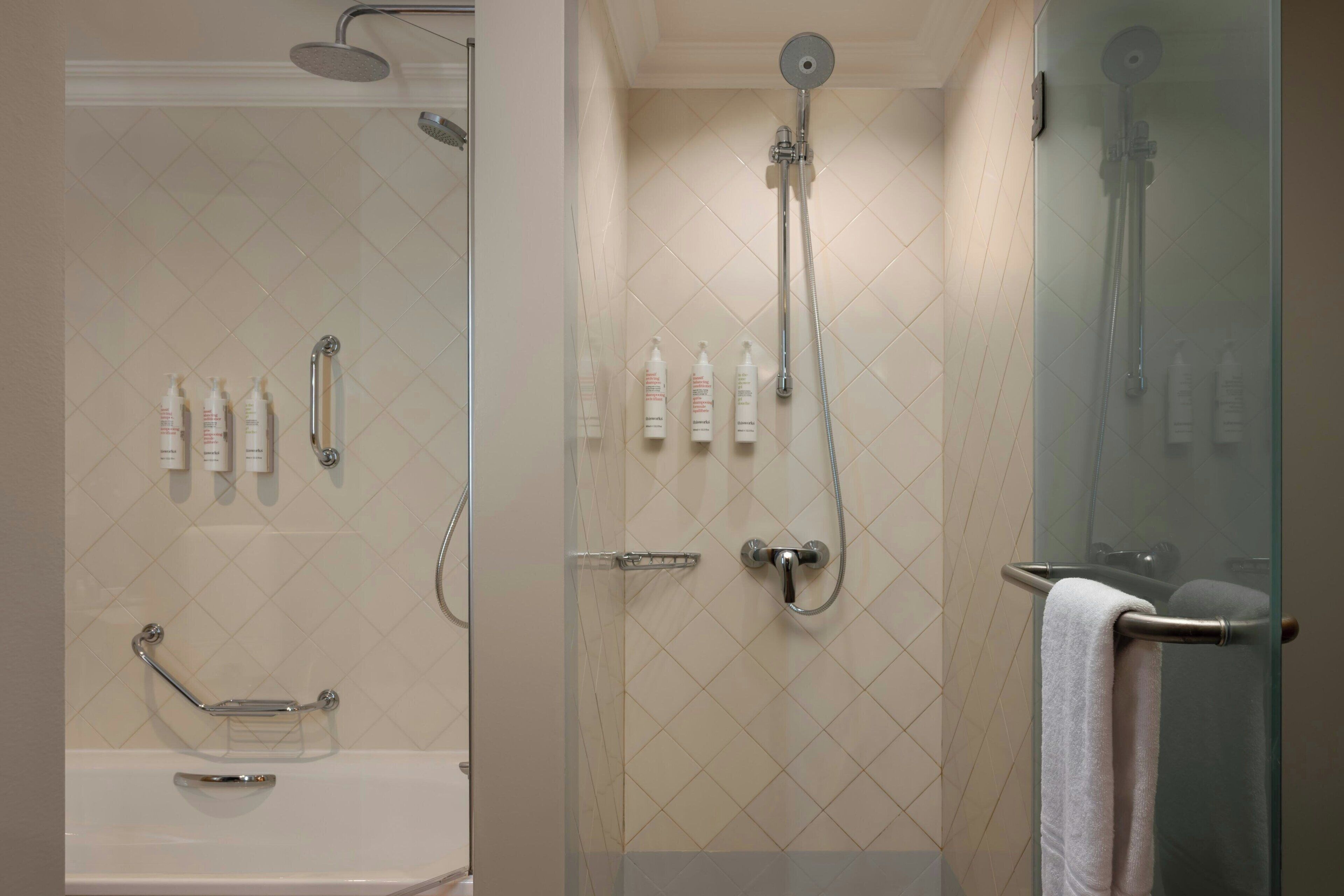 A modern bathroom with a glass-enclosed shower, a glass-enclosed toilet, and a bathtub.