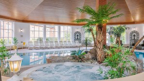 An indoor swimming pool with a hot tub, surrounded by lounge chairs and potted plants. - Muthu Belstead Brook Hotel (Ipswich)