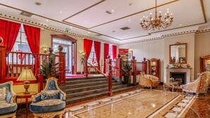 A grand lobby with a marble floor, red curtains, and classic furniture. - Muthu Belstead Brook Hotel (Ipswich)