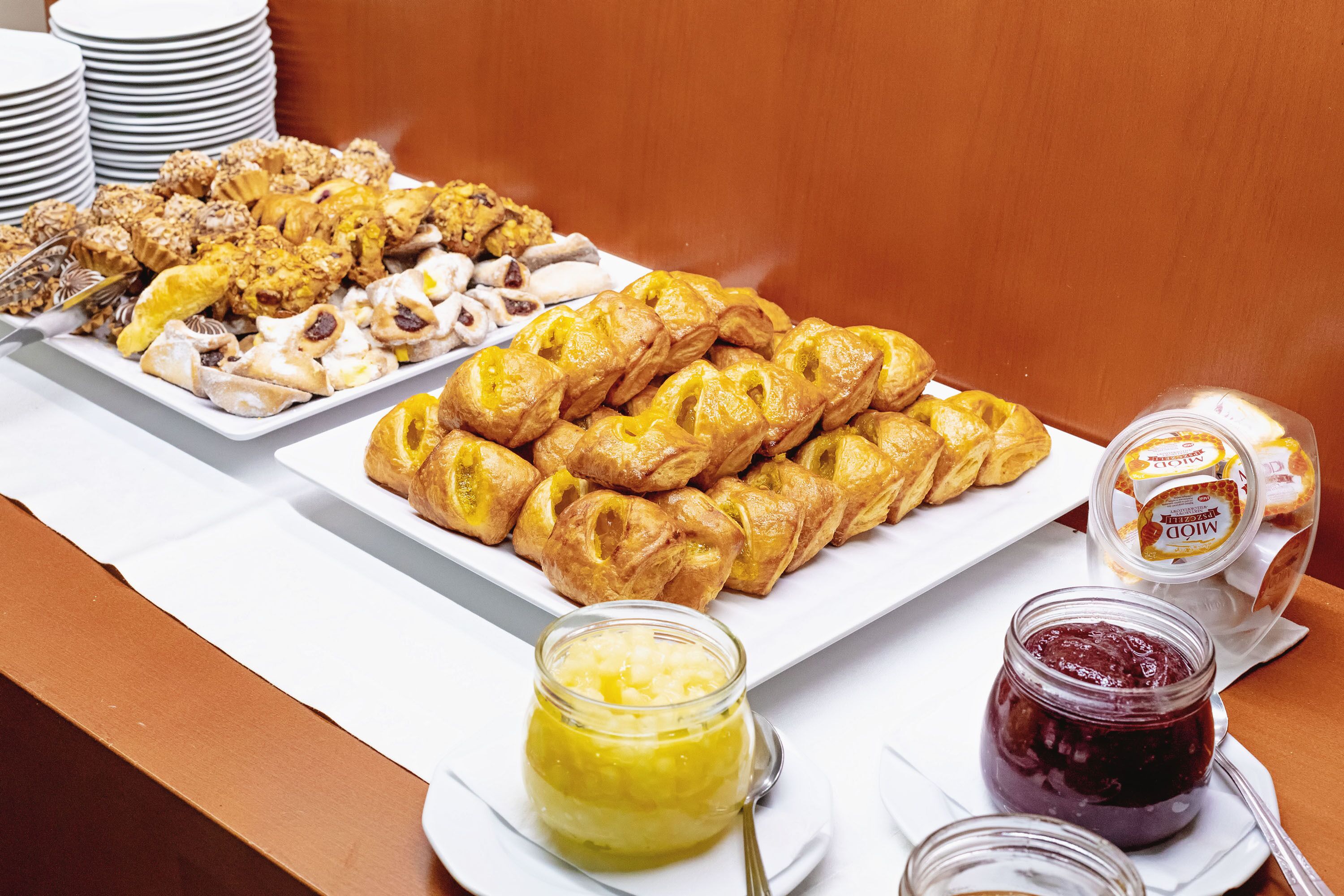 A buffet with various pastries and spreads.