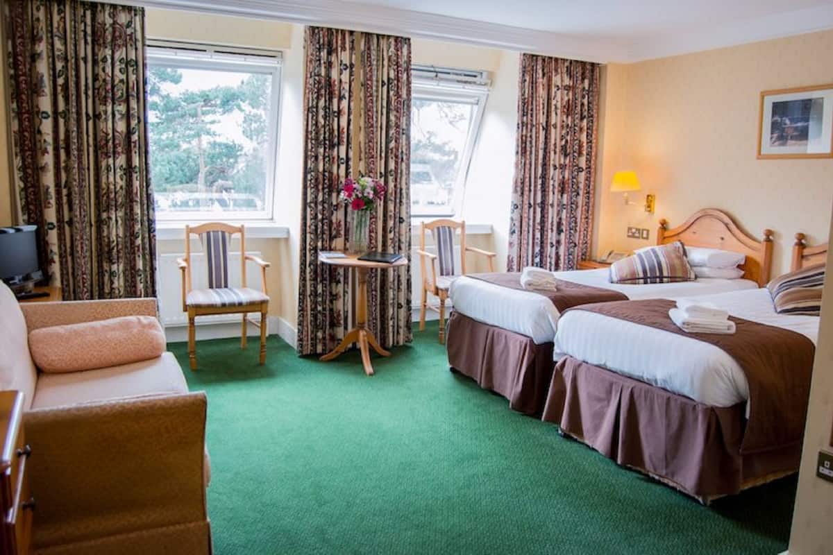 family room | desk, iron/ironing board, bed sheets, alarm clocks