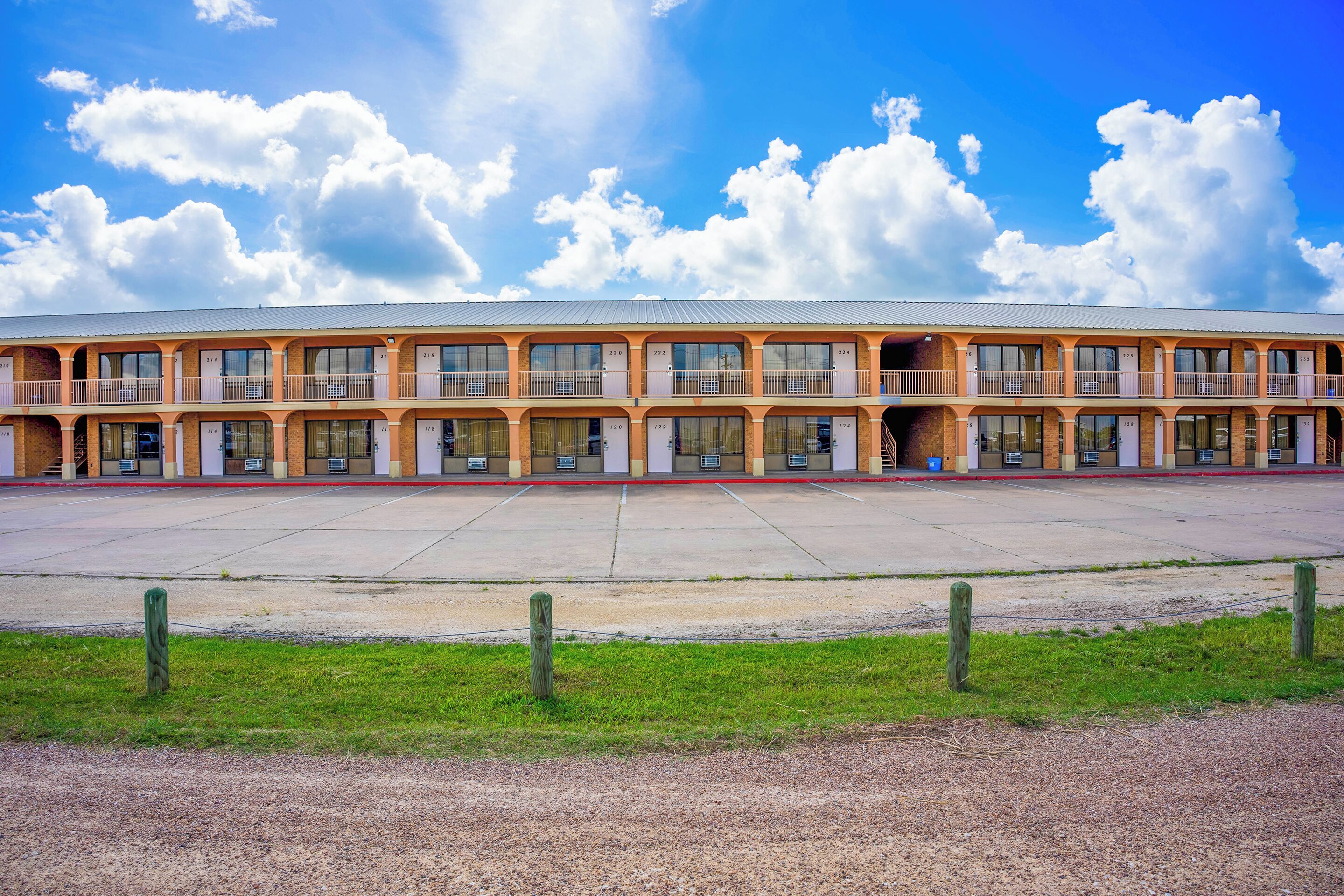 A large, multi-story building with a flat roof and multiple balconies.
