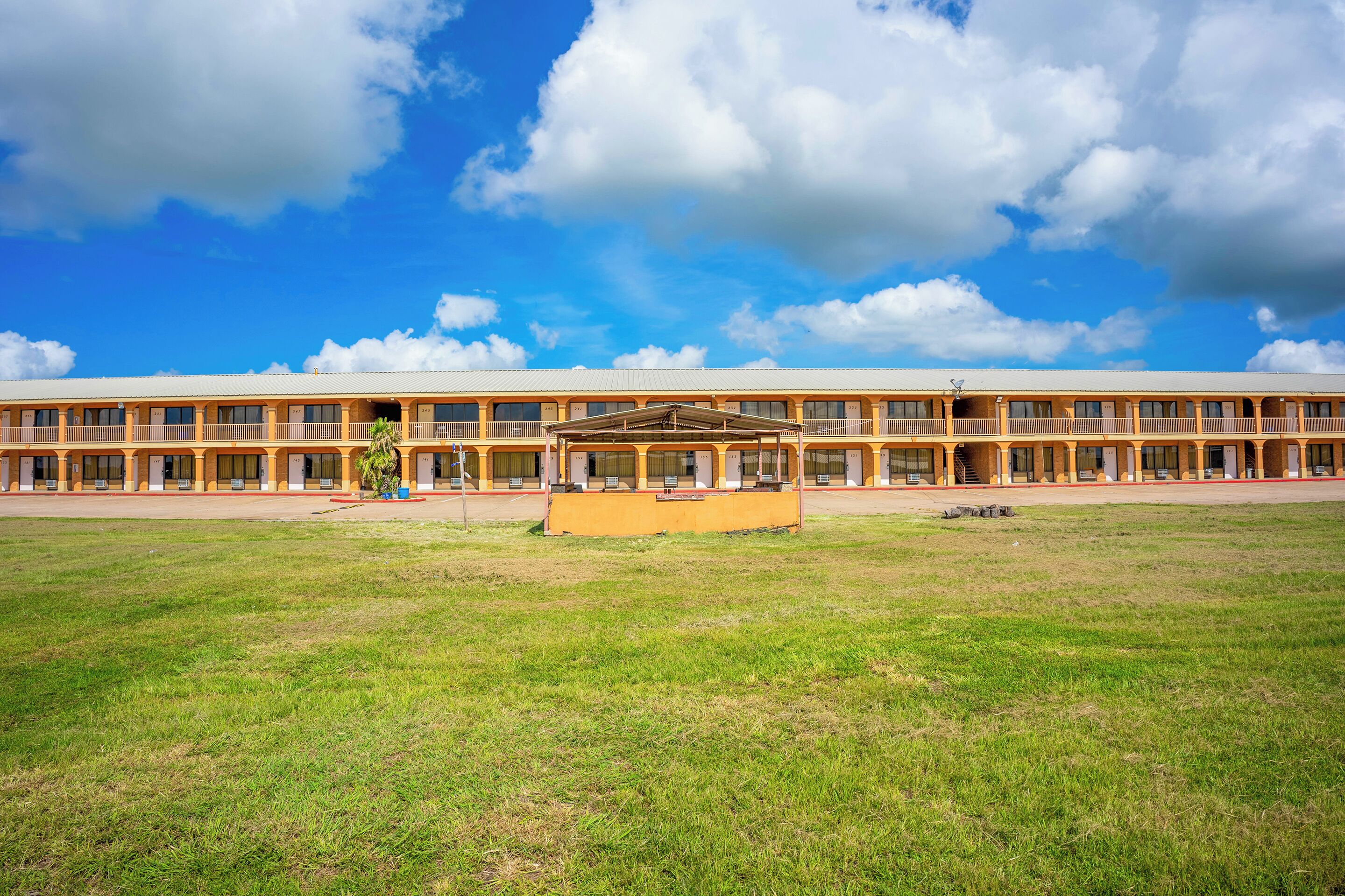A long, single-story building with a flat roof and a central courtyard.