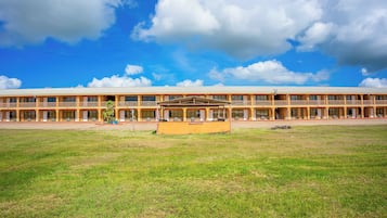A long, single-story building with a flat roof and a central courtyard.