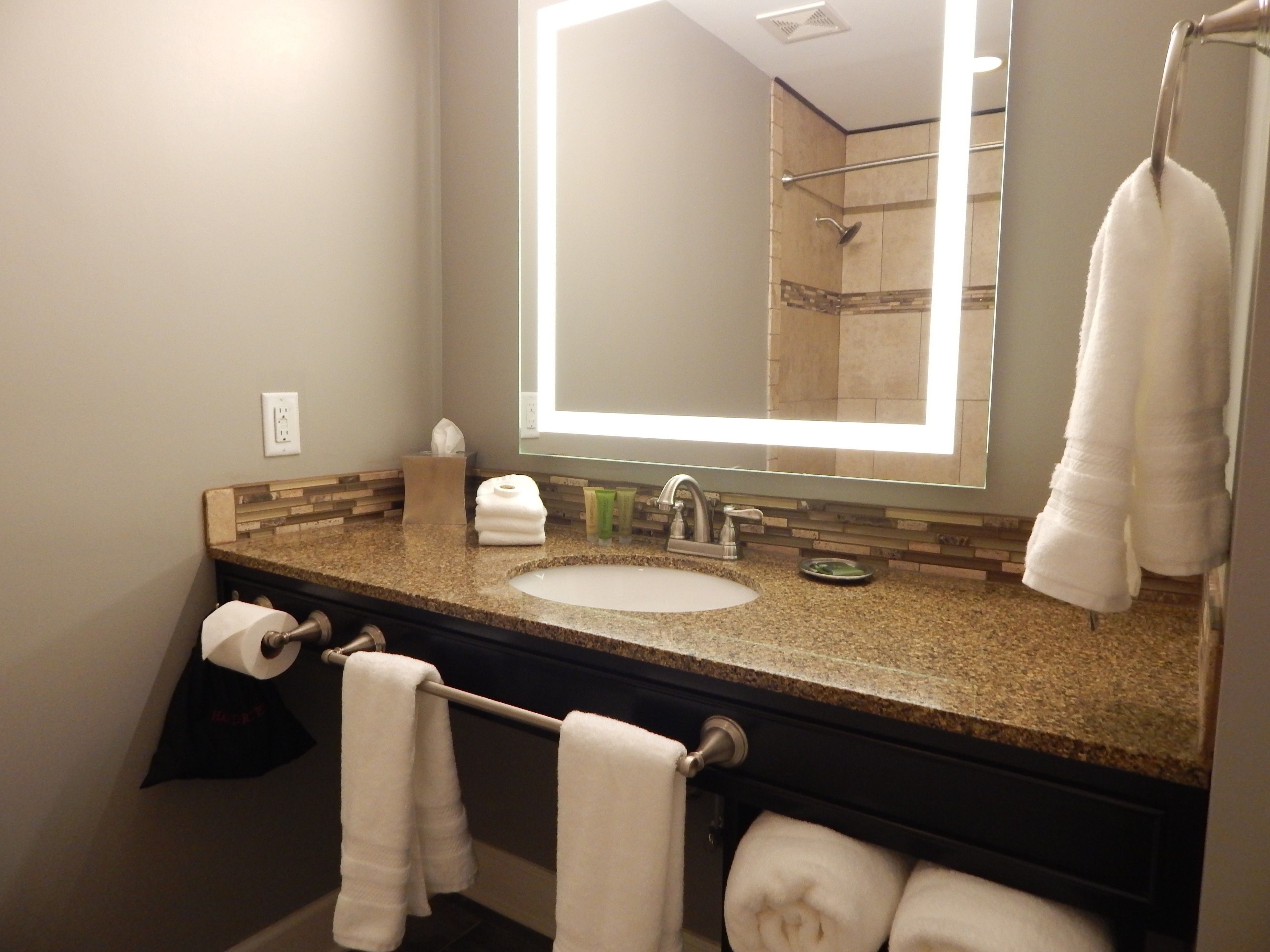 designer toiletries, hair dryer, towels