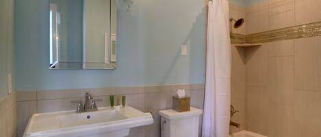 Une salle de bain avec un lavabo, des toilettes et une baignoire.