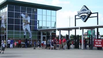 A baseball stadium with a large glass facade and a Trustmark Park sign.