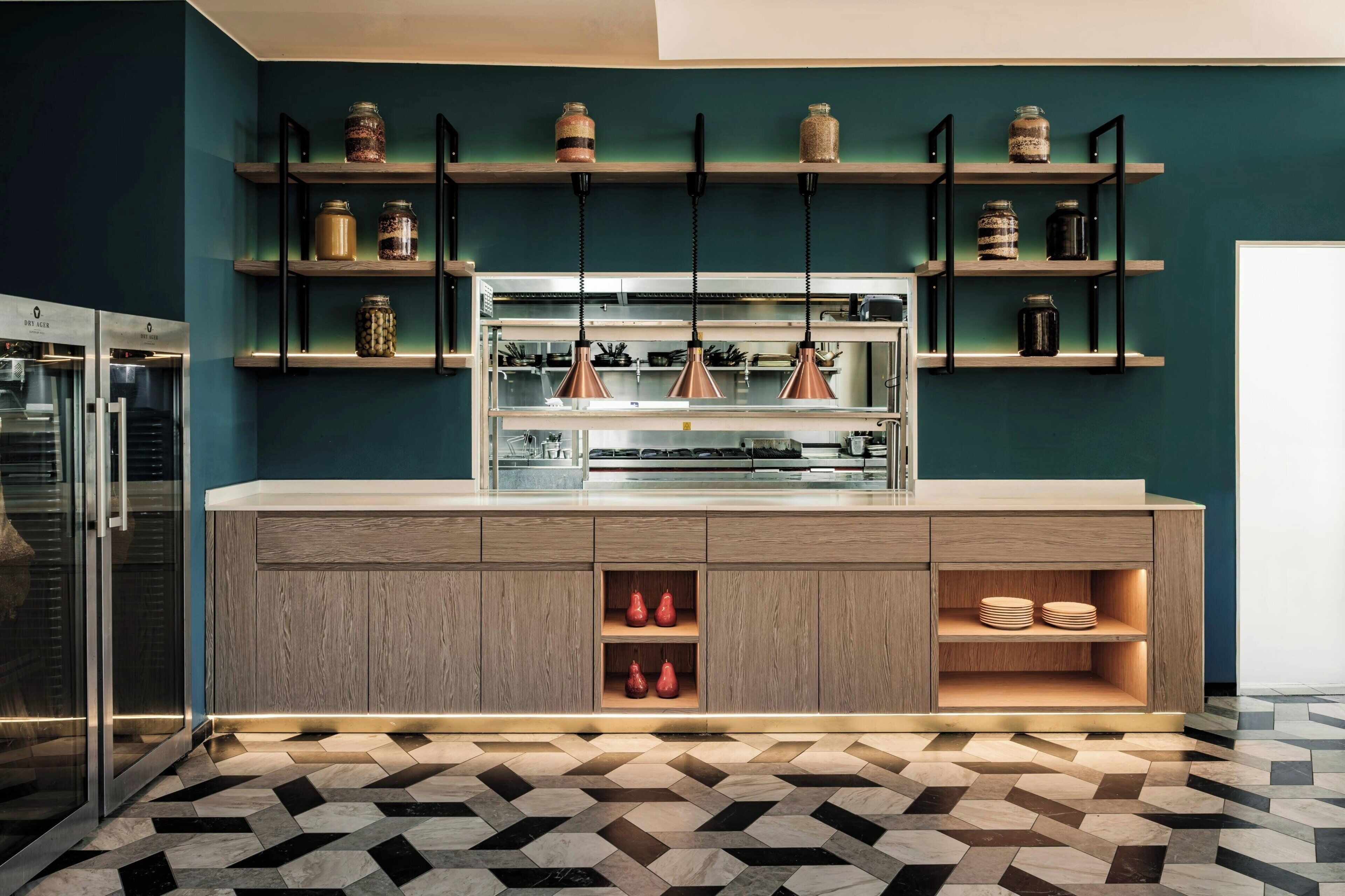 A modern kitchen with wooden cabinets, a central island, and a patterned floor.