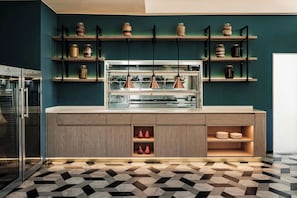 A modern kitchen with wooden cabinets, a central island, and a patterned floor.