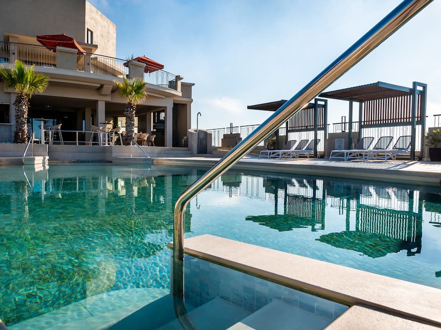 Una piscina techada, sillones reclinables de piscina