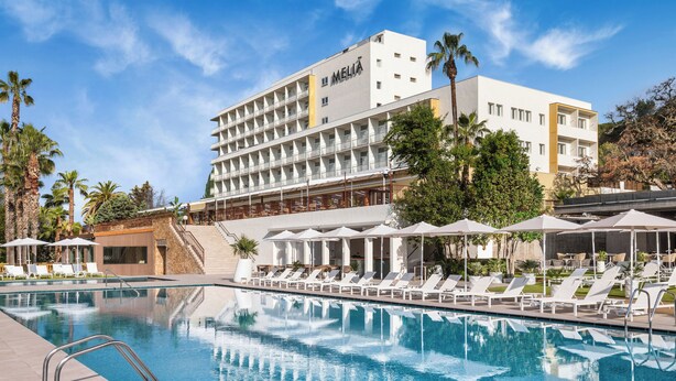 A hotel with a swimming pool, sun loungers, and palm trees. - Melia Lloret de Mar (Lloret de Mar)