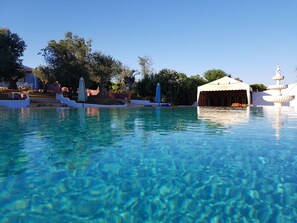 Piscine extérieure, parasols de plage, chaises longues