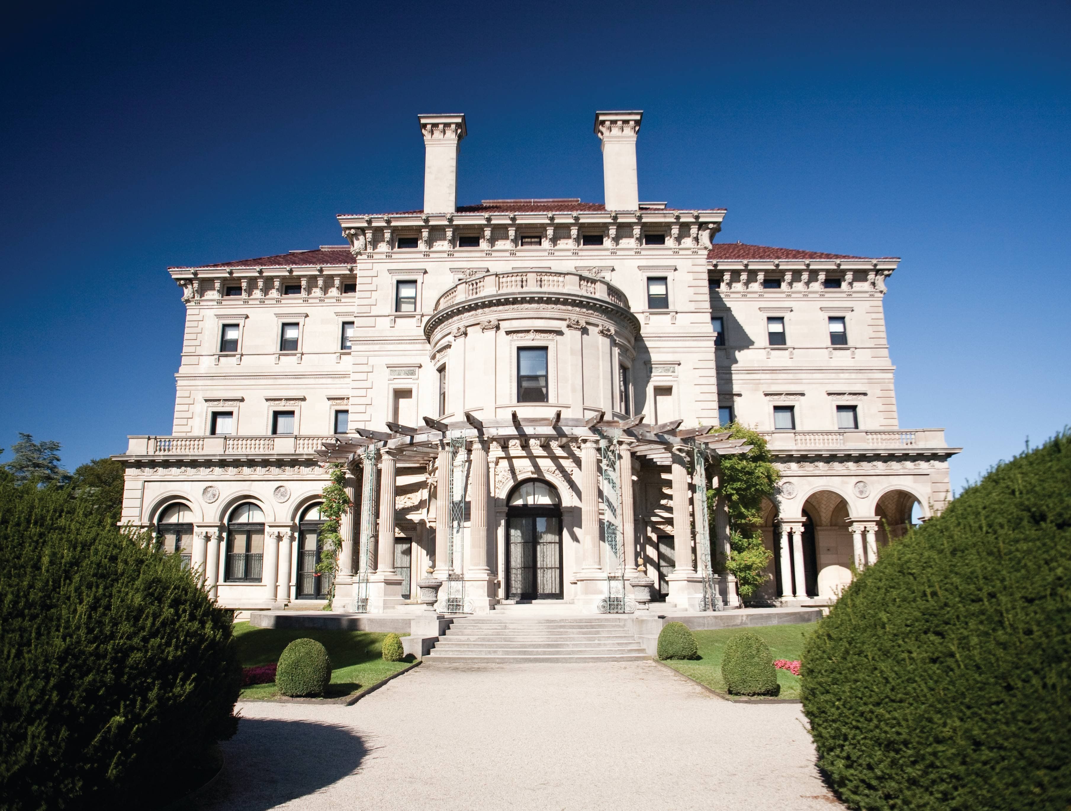 A large, stately building with a grand entrance, multiple windows, and a symmetrical facade.