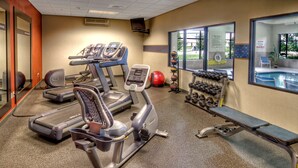 A gym with treadmills, ellipticals, free weights, and a bench. - Hampton Inn & Suites Boise/Nampa at the Idaho Center (Nampa)