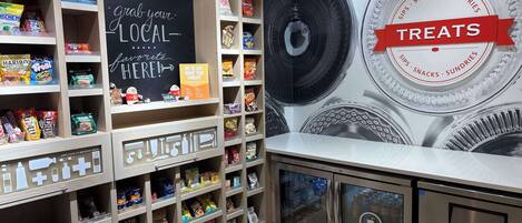 A snack display area with various packaged snacks and a chalkboard sign.