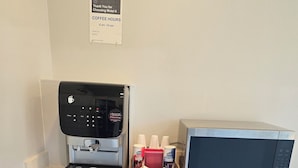 A kitchenette with a coffee machine, a microwave, and a cabinet with drawers. - Motel 6 Los Angeles, CA - Downtown (Los Angeles)