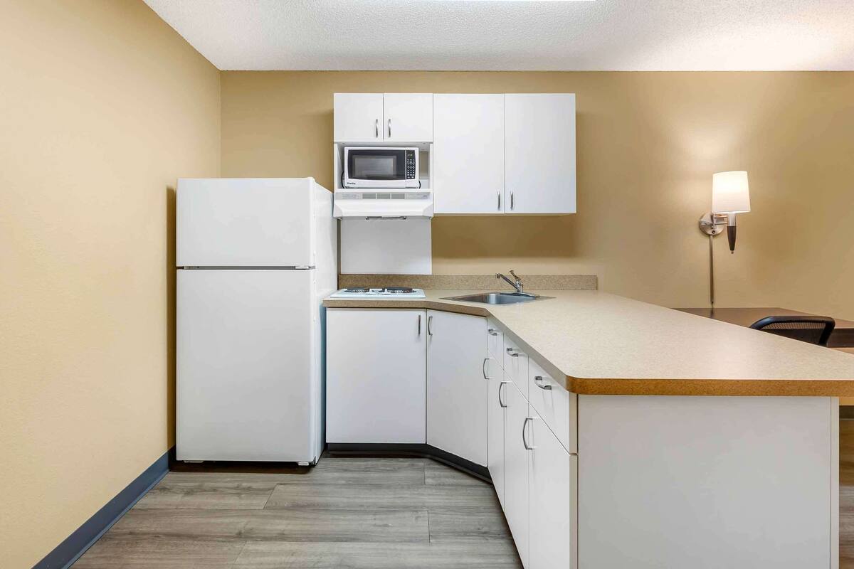 full-sized fridge, microwave, stovetop, coffee/tea maker