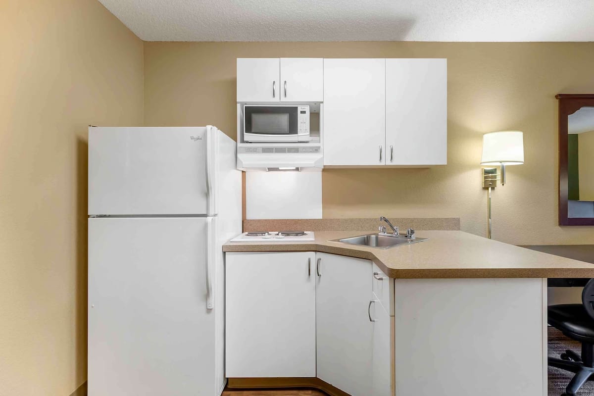 full-sized fridge, microwave, stovetop, coffee/tea maker