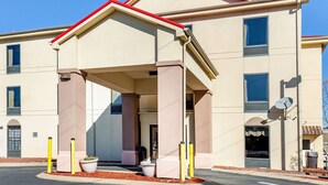 A multi-story hotel with a covered entrance, large windows, and a satellite dish. - Econo Lodge Lookout Mountain (Chattanooga)