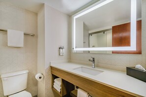 A modern bathroom with a white sink, wooden vanity, and a large mirror. - Holiday Inn Express Hotel & Suites Buffalo-Airport by IHG (Buffalo)