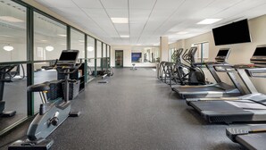 A gym with treadmills, exercise bikes, and a mirrored wall. - Holiday Inn Express Hotel & Suites Buffalo-Airport by IHG (Buffalo)