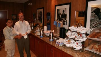 A buffet area with various food items and a counter.