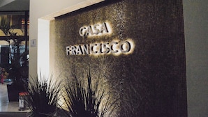 A wall with the text "CASA FRANCISCO" in illuminated letters.