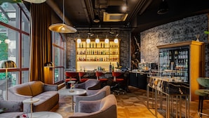 A modern bar area with seating, a wine rack, and a refrigerator. - Hotel Haffner Resort & SPA - Destigo Hotels (Sopot)