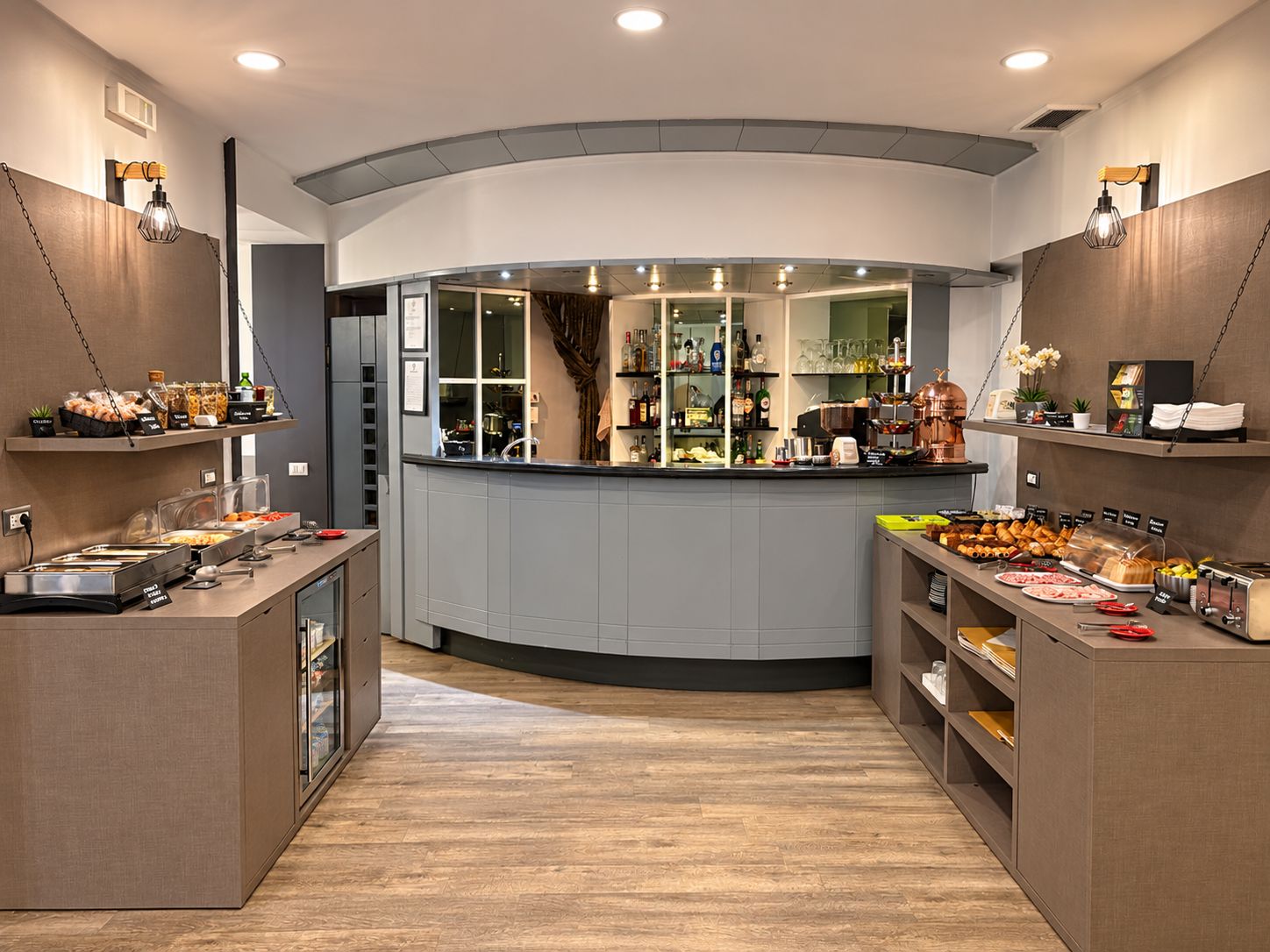 A modern kitchen with a curved island, equipped with various appliances and food items.
