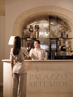 Una recepción con un letrero que dice 'VRETREATS PALAZZO ARTEMIDE Tu Refugio en Siracusa'.
