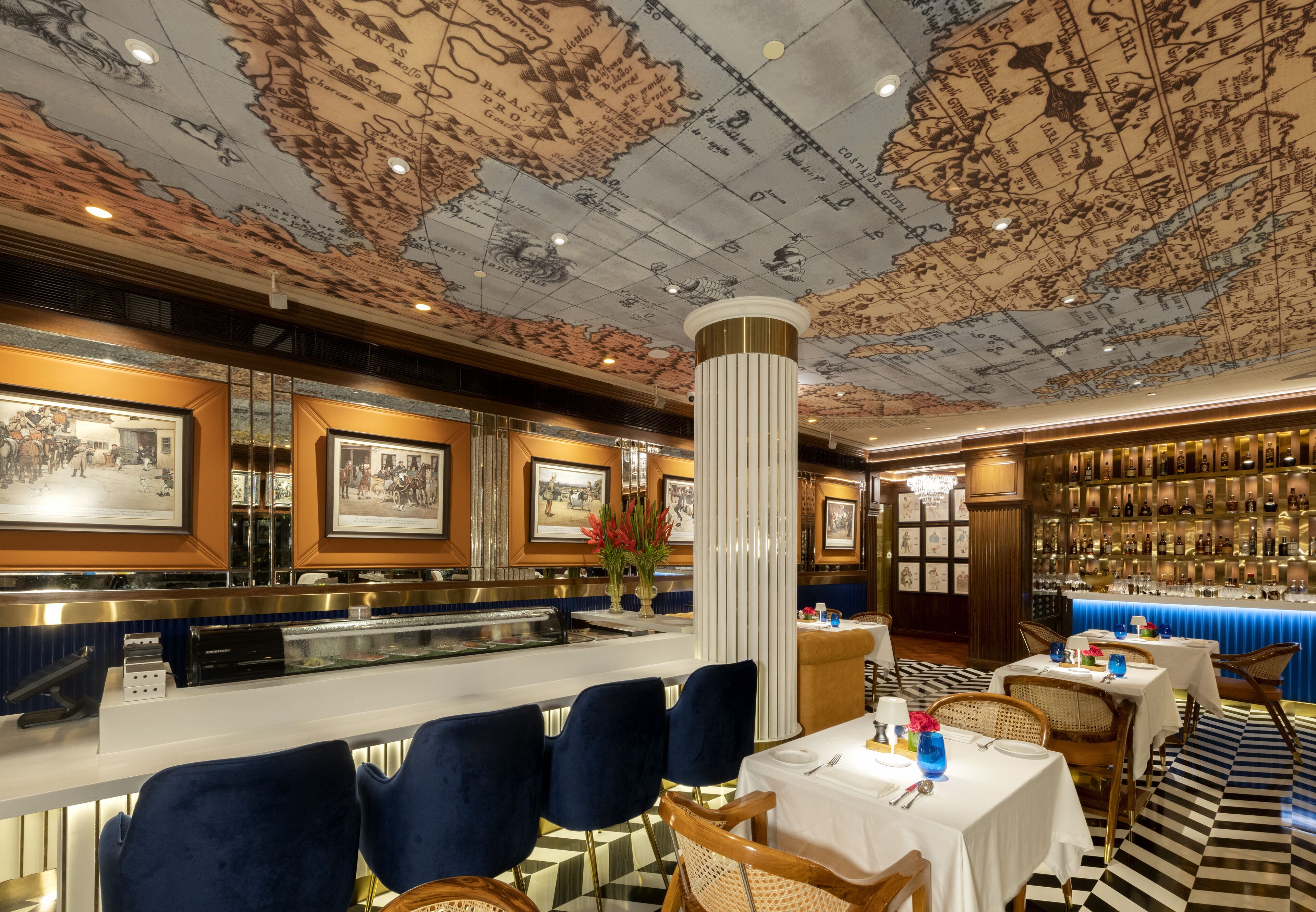 A restaurant with a vintage map ceiling, framed pictures on the walls, a bar area, and a mix of modern and classic furniture.