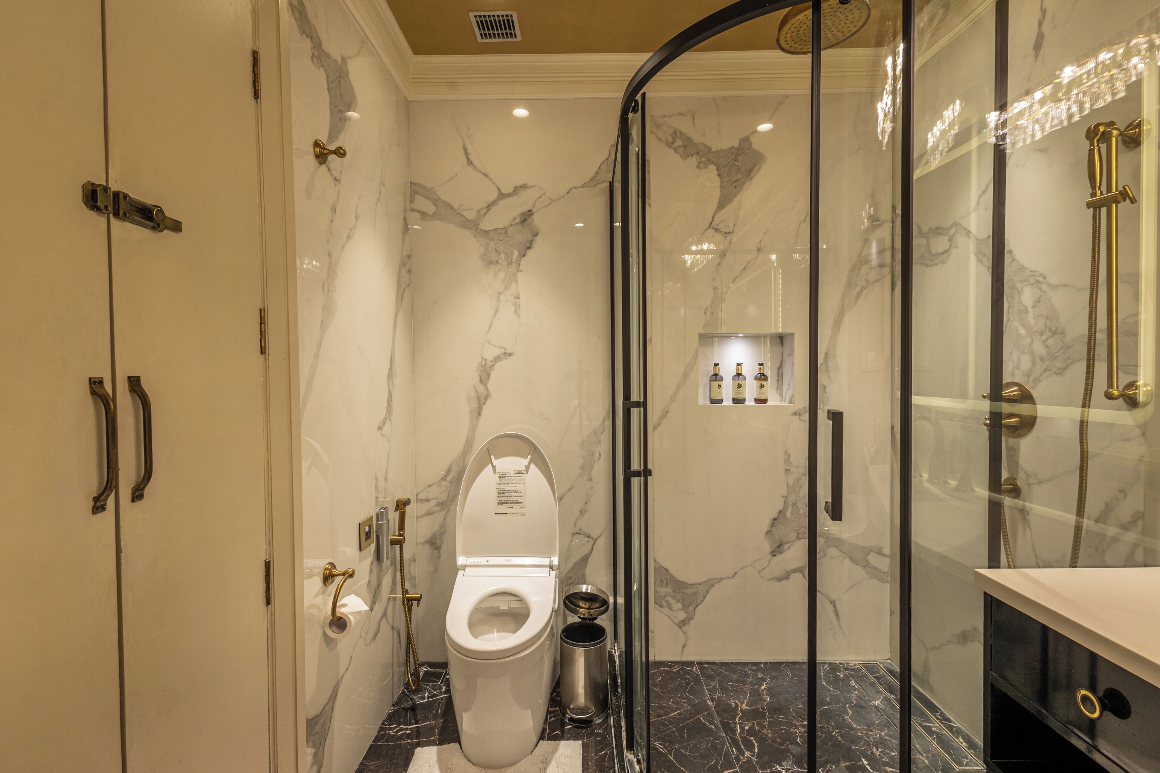 A modern bathroom with a toilet, bidet, and shower.