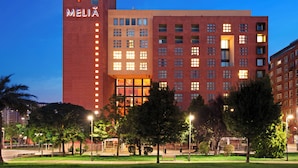 A modern hotel with a prominent 'MELIA' sign, multiple floors, and a well-lit facade. - Hotel Melia Bilbao (Bilbao)