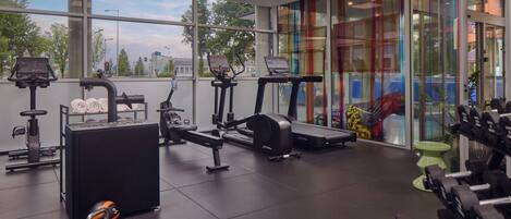 A gym with various exercise equipment, including treadmills and weight machines.