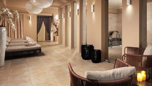 A modern spa room with a seating area, a massage table, and a shower area. - Kosher Hotel KING DAVID Prague (Prague)
