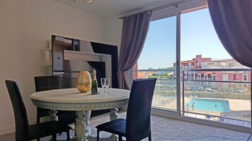 Suite, 2 Bedrooms, Pool View (6 persons) | Living area | Flat-screen TV